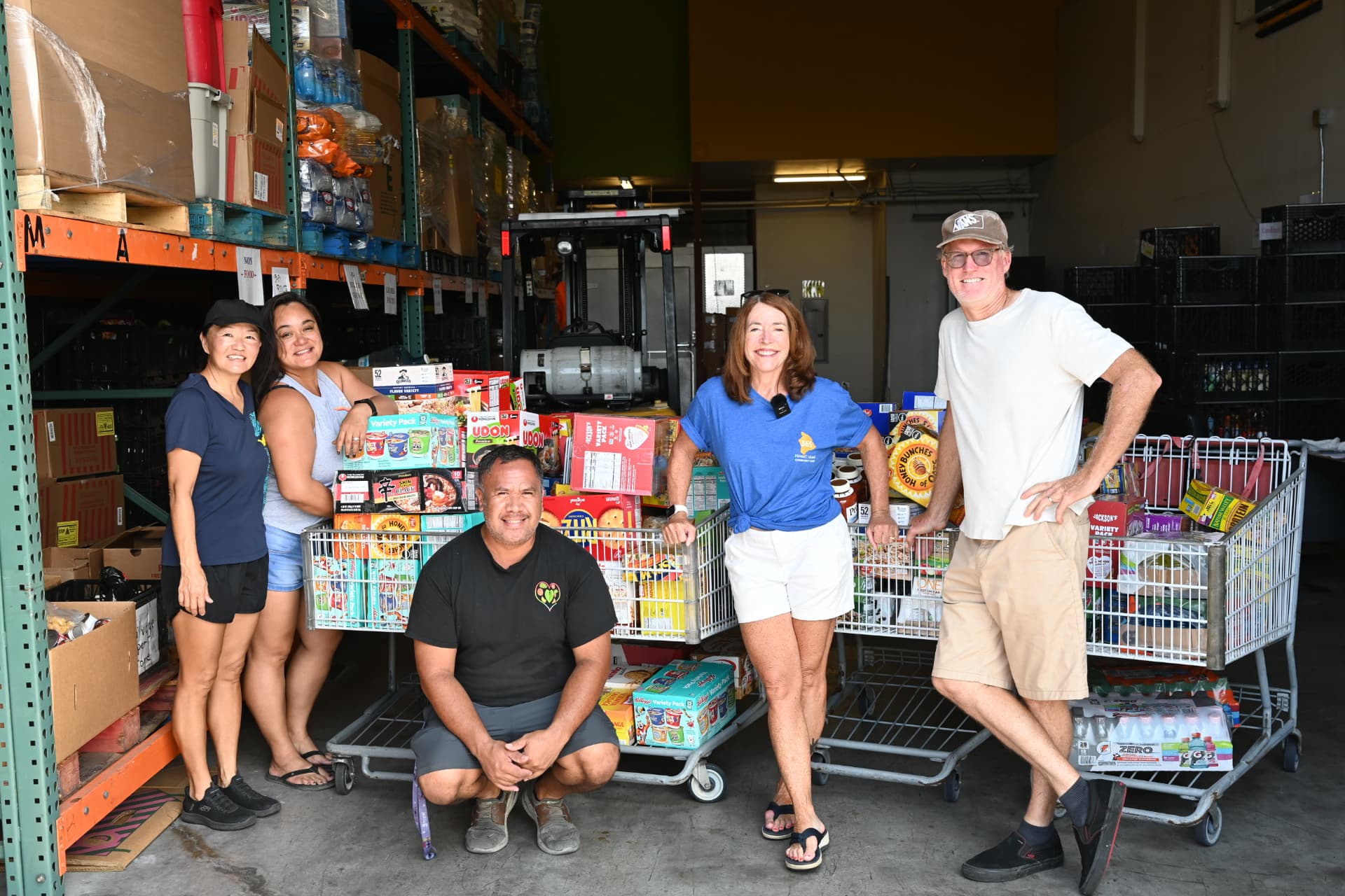 Luana Hospitality Group ʻohana loading carts of storm relief supplies with 365 Hawaiʻi Island Community Fund