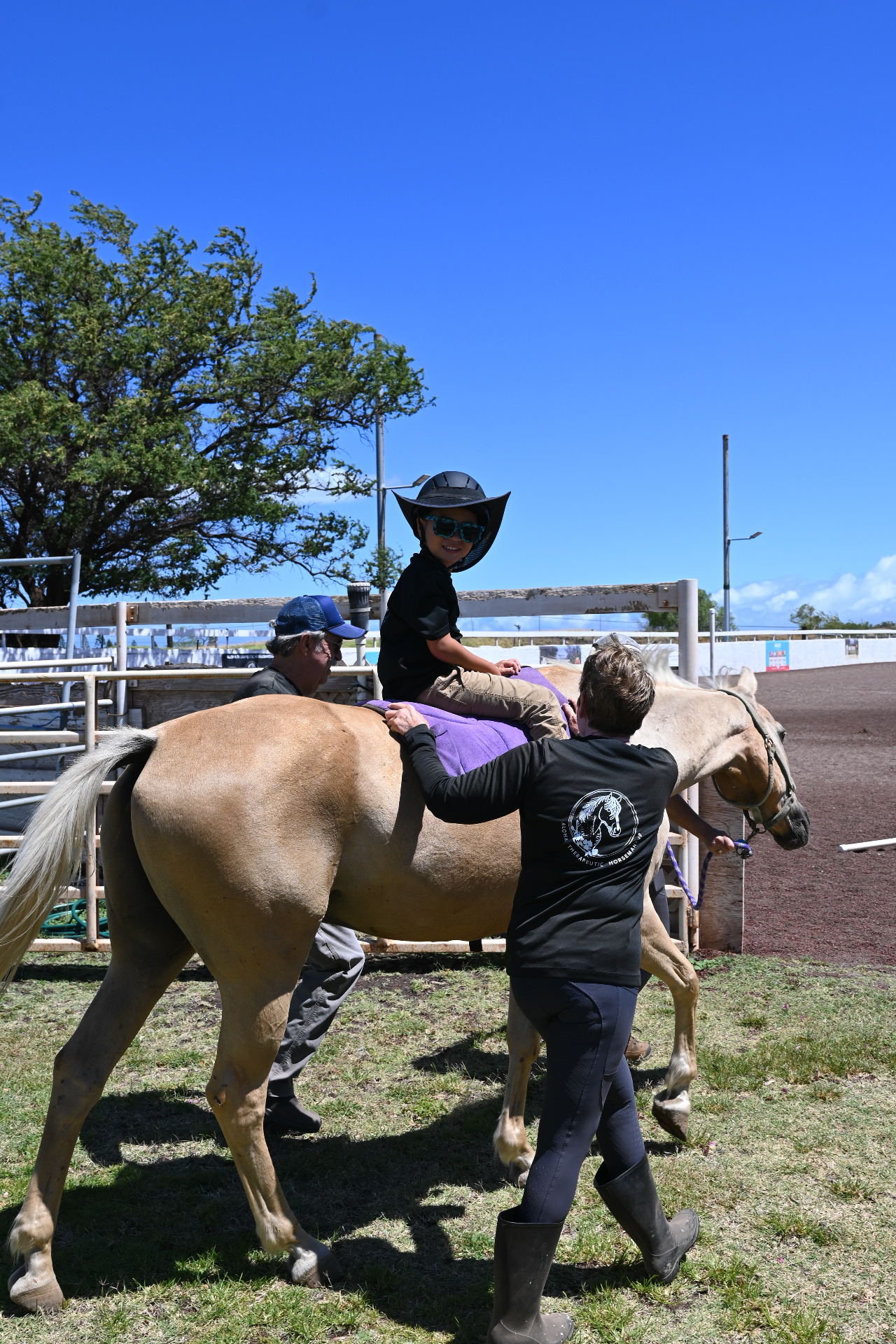 Aloha Therapeutic Horsemanship session with a child on a horse and two volunteers